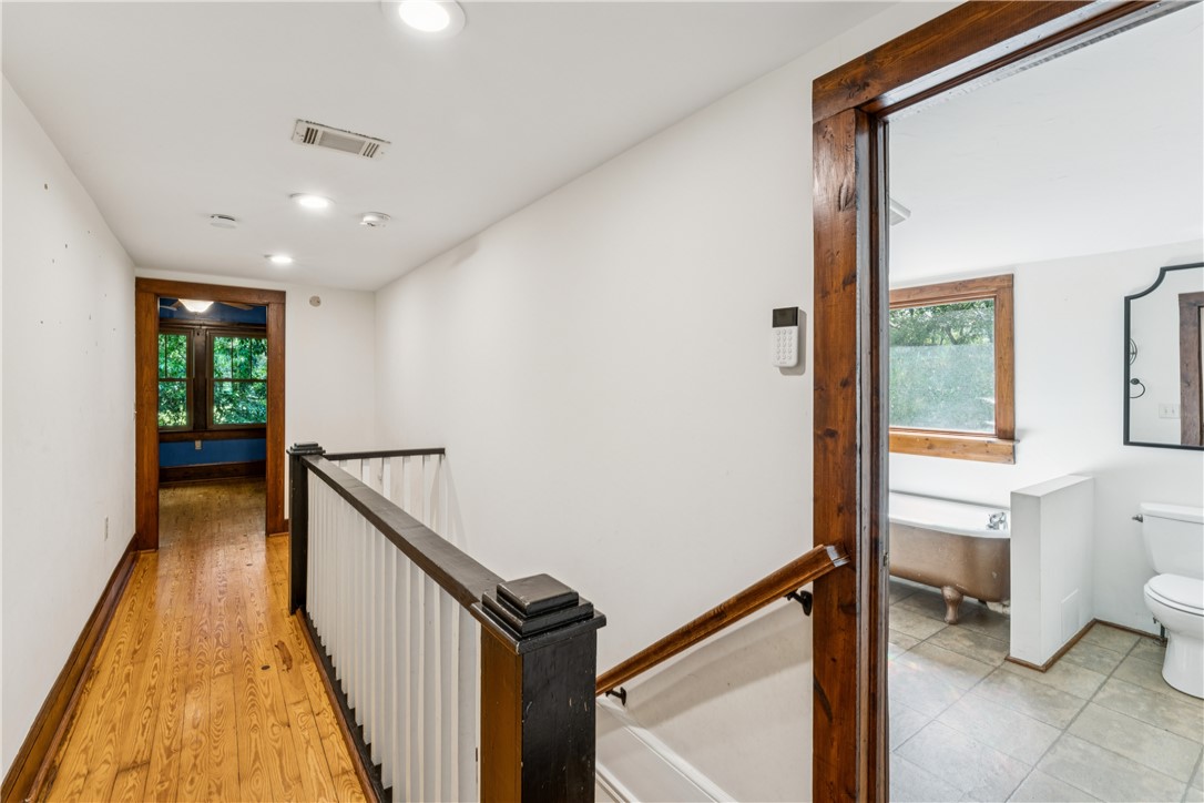 321 South Pine Street Walhalla, SC 29691 - Photo 23 of 28 Hardwood floors and crisp white walls define this well-lit upper-level landing, leading to a charming bathroom.