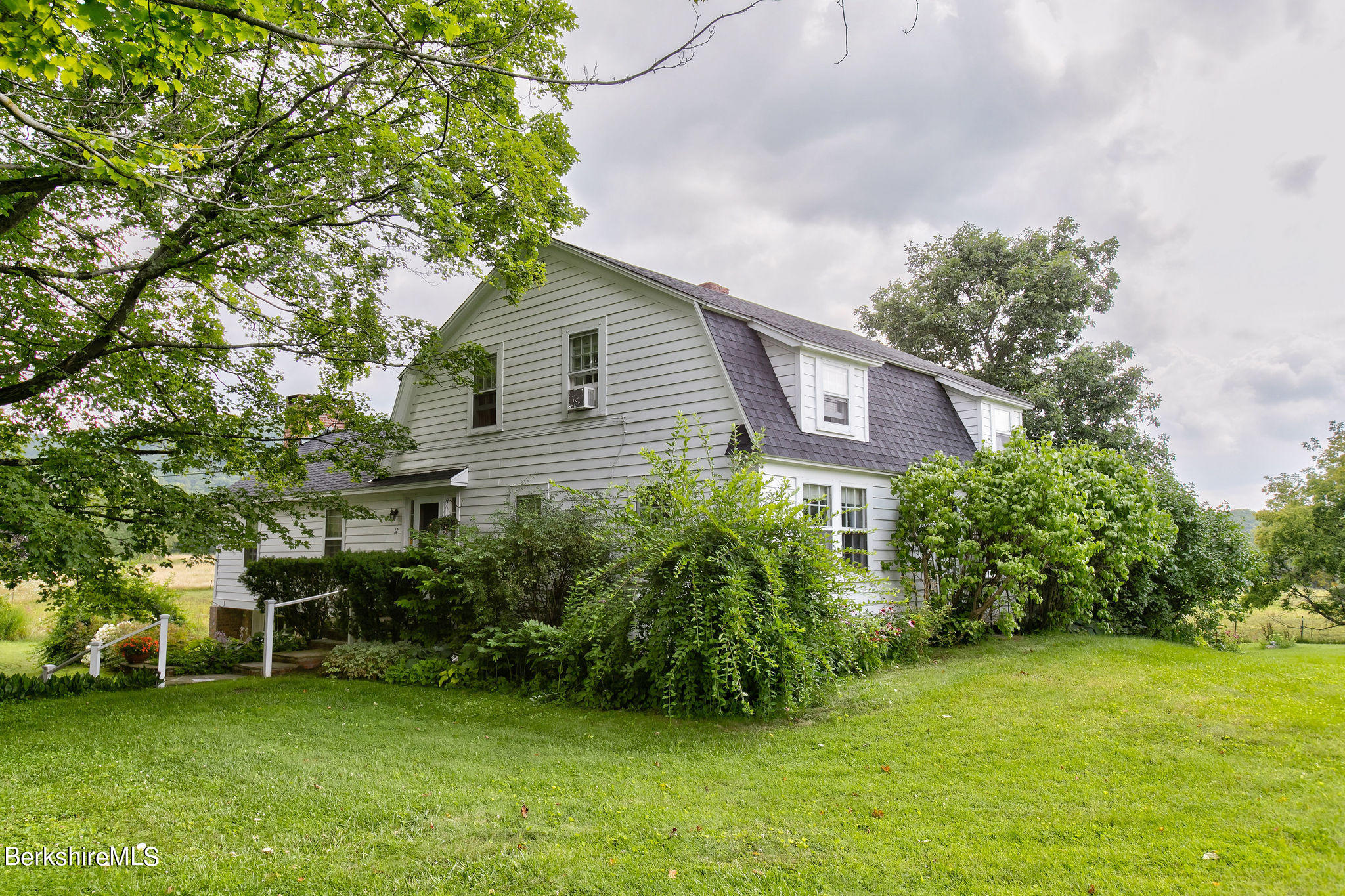 32 Prospect Hill Road Stockbridge, MA 01262 - Photo 2 of 30 a house that has a tree in front of it