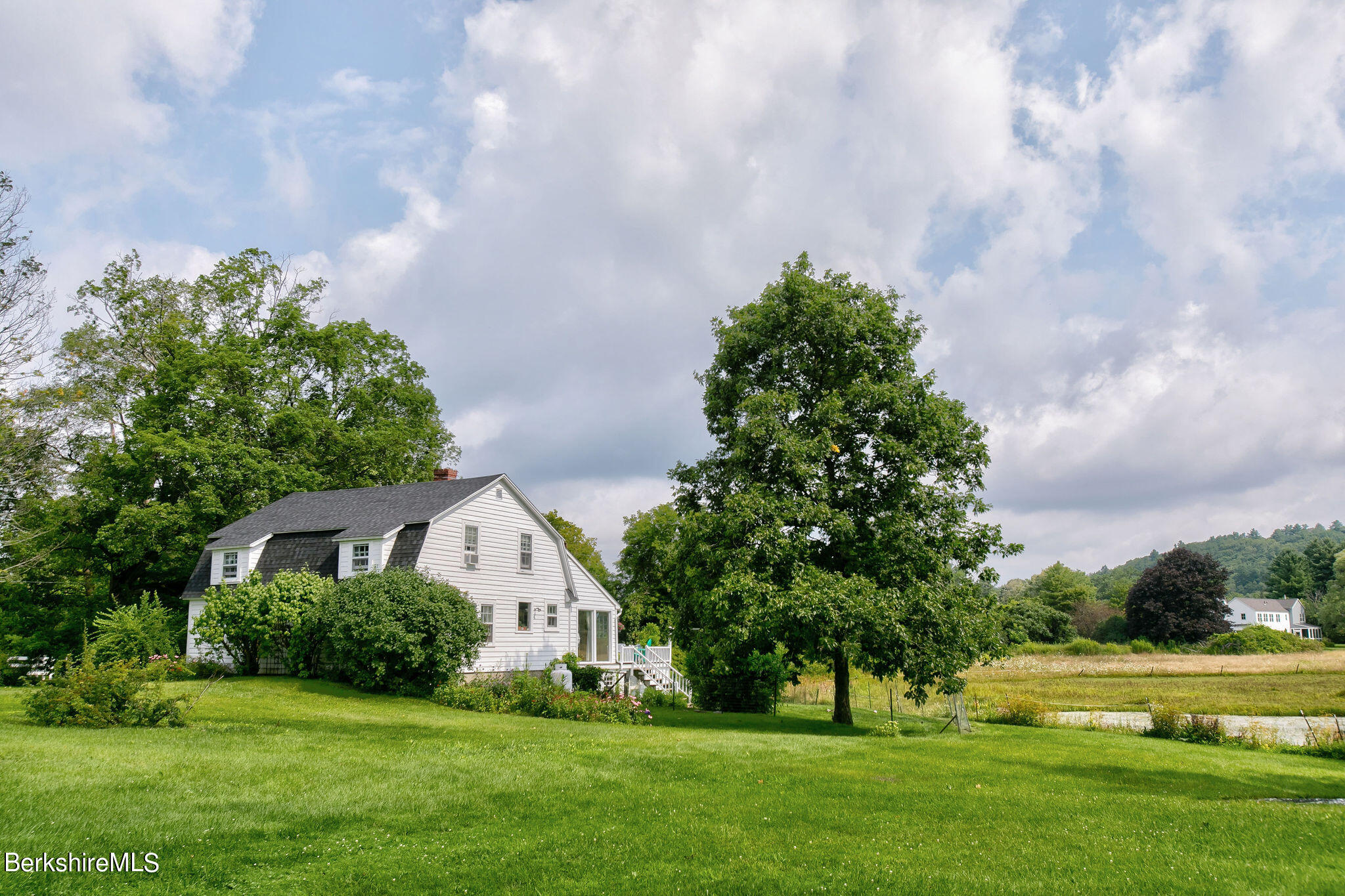 32 Prospect Hill Road Stockbridge, MA 01262 - Photo 3 of 30 a view of white house with a big yard and potted plants