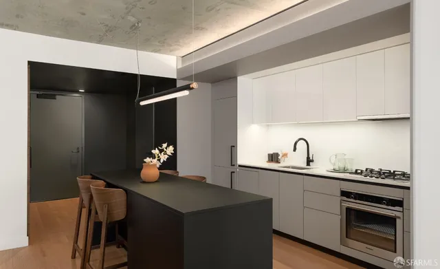 a kitchen with a sink cabinets and stainless steel appliances
