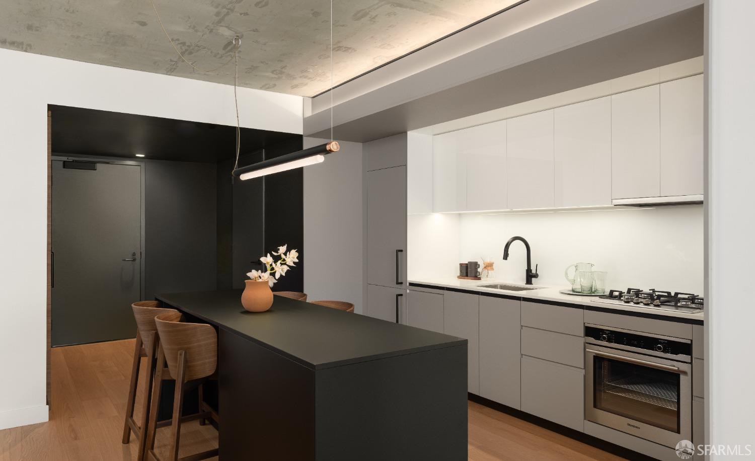 960 Market Street, Unit 807 San Francisco, CA 94102 - Photo 2 of 13 a kitchen with a sink cabinets and stainless steel appliances