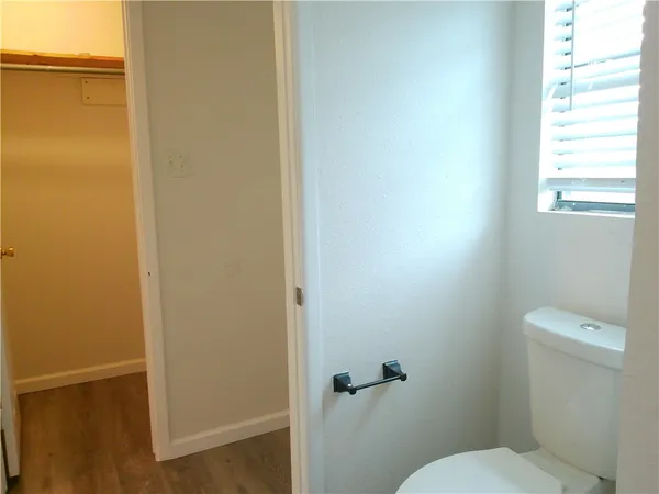 a white toilet sitting next to a window