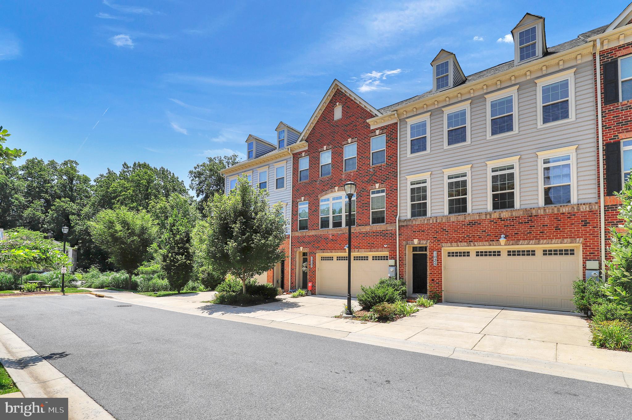 1025 Mutual Place Sandy Spring, MD 20860 - Photo 1 of 1 a front view of a building with a yard and a garage