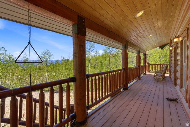 2096 South Aspen Ridge Coalville, UT 84017 - Photo 31 of 44 Expansive covered porch featuring a wood-finish floor, wood-paneled ceiling with recessed lighting, and log-style structural columns