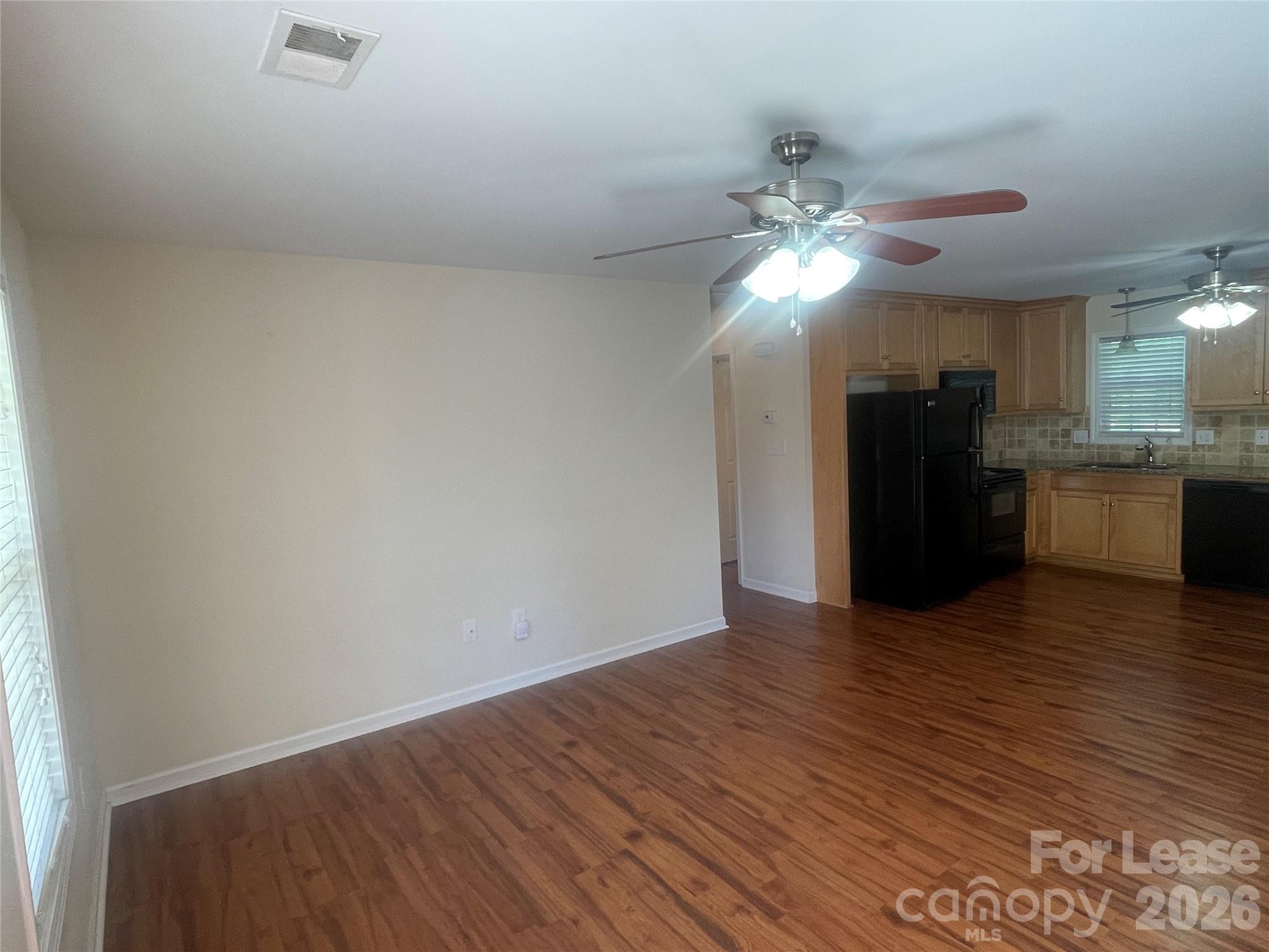 3791 Lee Moore Road Maiden, NC 28650 - Photo 3 of 11 a view of a kitchen with wooden floor and a ceiling fan