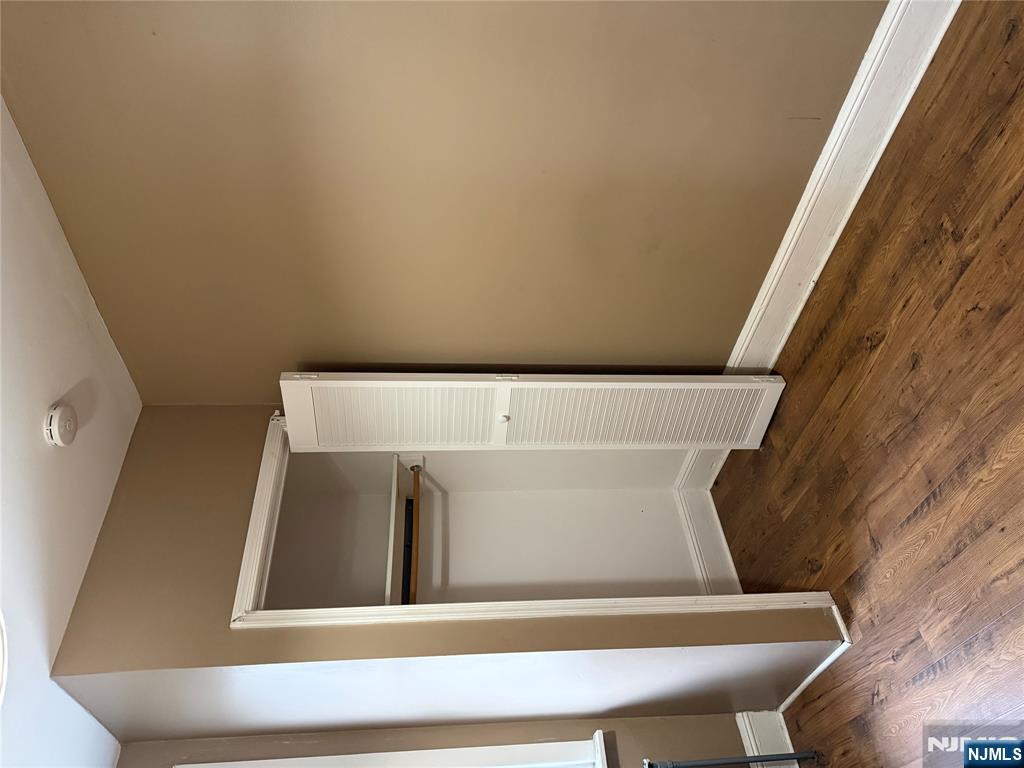439 Cliff Street, Unit 2 Fairview, NJ 07022 - Photo 3 of 12 a view of an empty room with wooden floor and closet