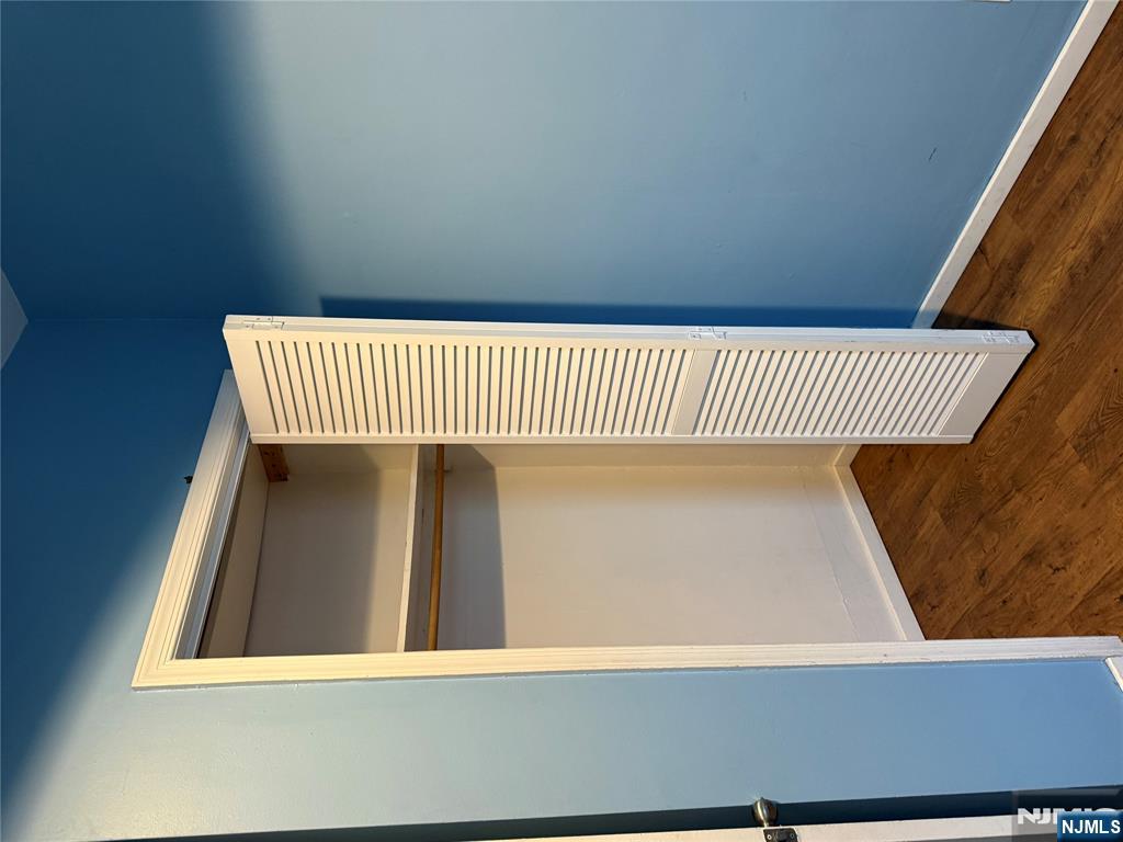 439 Cliff Street, Unit 2 Fairview, NJ 07022 - Photo 8 of 12 an empty room with wooden floor and closet