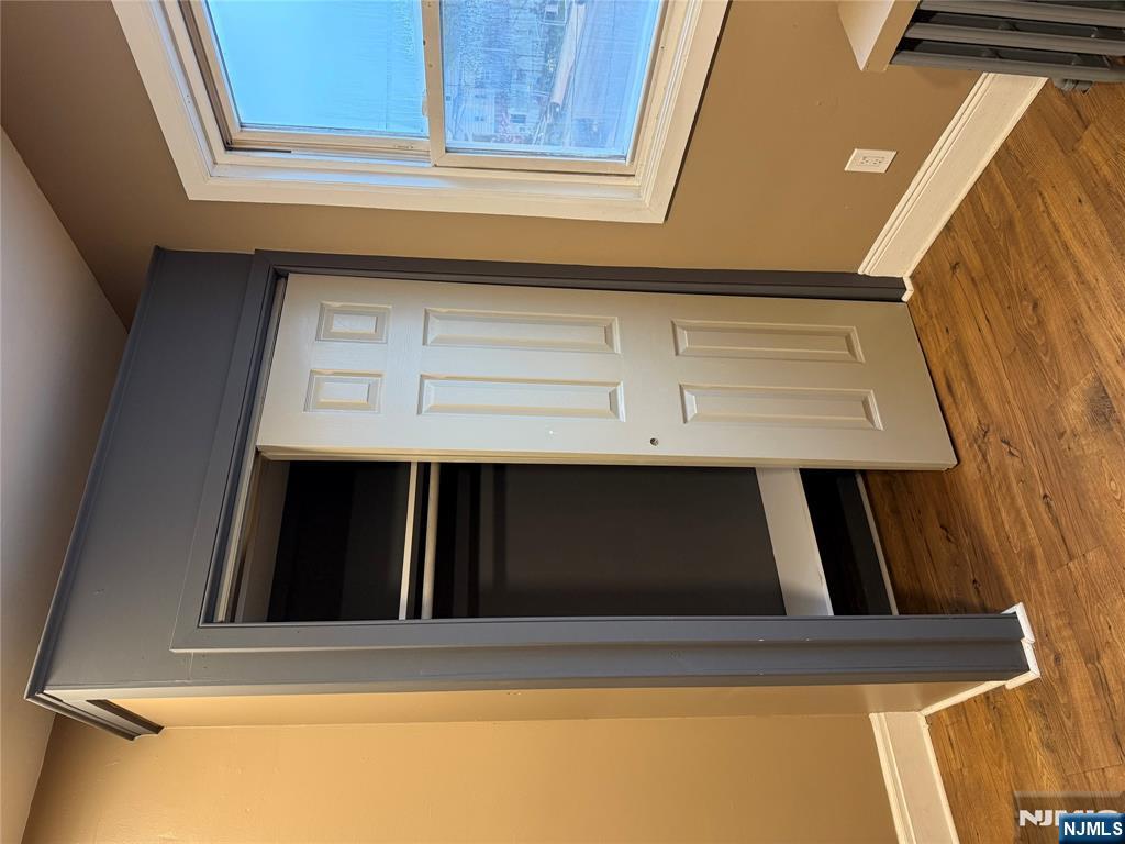 439 Cliff Street, Unit 2 Fairview, NJ 07022 - Photo 10 of 12 a view of a hallway with wooden floor and closet