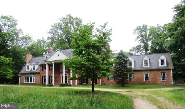 9207 Belmart Road Potomac, MD 20854 - Photo 1 of 13 a front view of a house with a yard