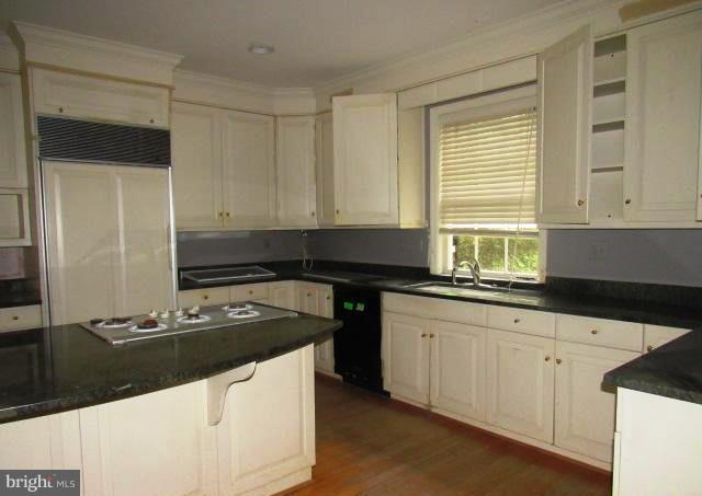 9207 Belmart Road Potomac, MD 20854 - Photo 9 of 13 a kitchen with granite countertop a sink and a stove