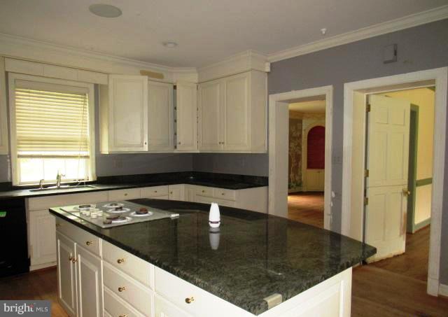 9207 Belmart Road Potomac, MD 20854 - Photo 10 of 13 a kitchen with a sink a stove and cabinets