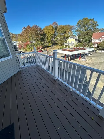 a view of balcony with wooden floor