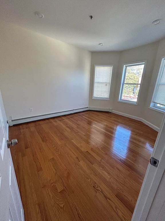 28 Harvard Avenue, Unit 3 Boston, MA 02121 - Photo 2 of 12 an empty room with wooden floor and windows