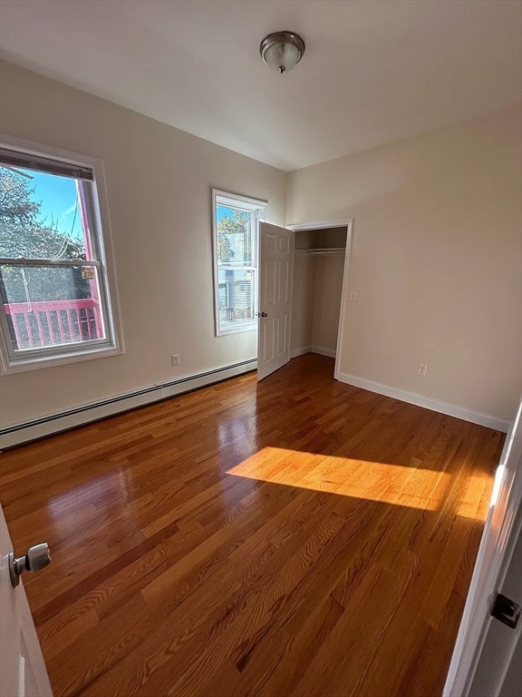 28 Harvard Avenue, Unit 3 Boston, MA 02121 - Photo 3 of 12 a view of an empty room with wooden floor and a window