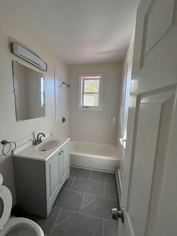 28 Harvard Avenue, Unit 3 Boston, MA 02121 - Photo 5 of 12 a bathroom with a double vanity sink toilet mirror and bathtub