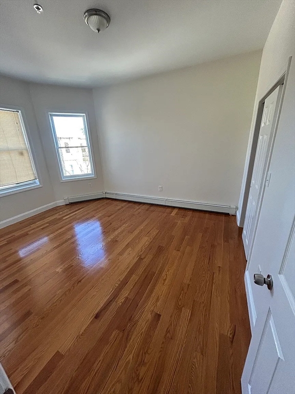 28 Harvard Avenue, Unit 3 Boston, MA 02121 - Photo 6 of 12 an empty room with wooden floor and windows