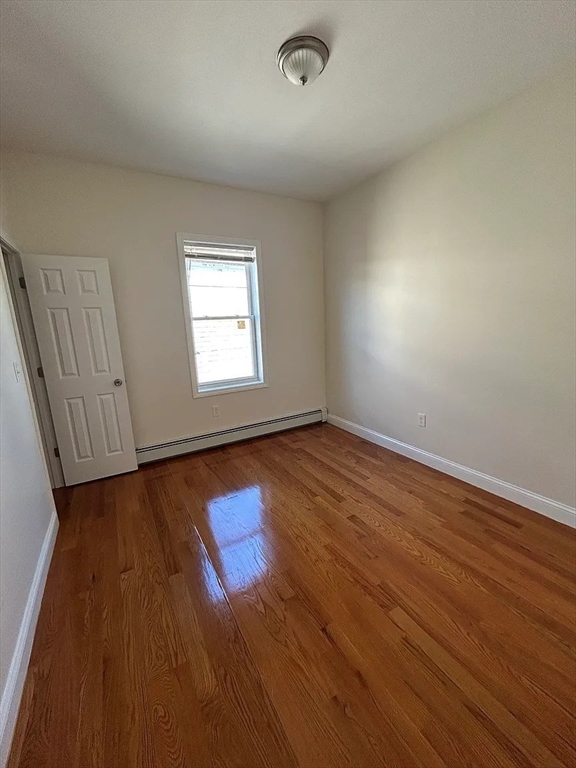 28 Harvard Avenue, Unit 3 Boston, MA 02121 - Photo 7 of 12 an empty room with wooden floor and windows