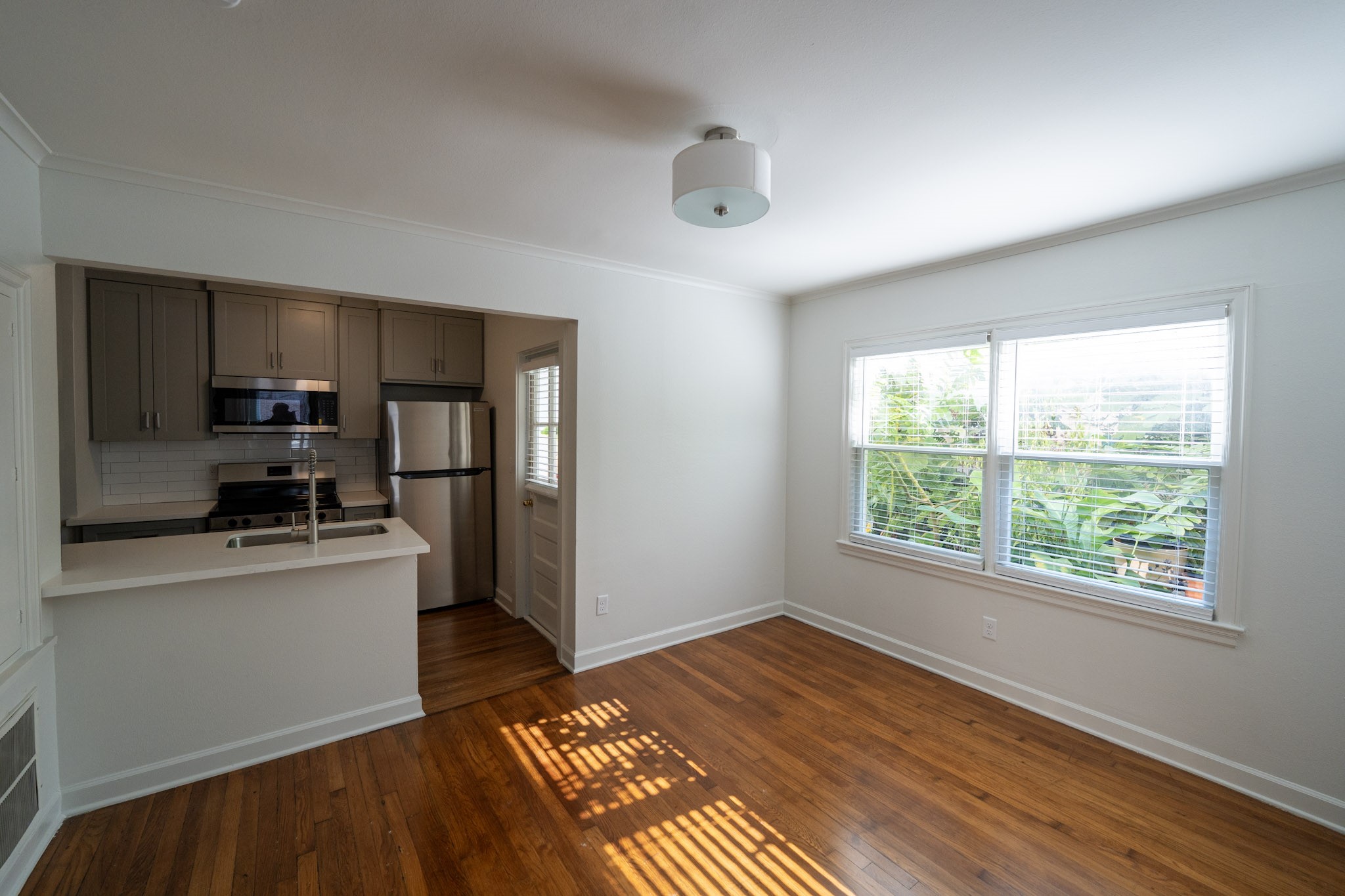 1913 Prospect Street, Unit 5 Houston, TX 77004 - Photo 3 of 17 a kitchen with stainless steel appliances a refrigerator and a stove top oven