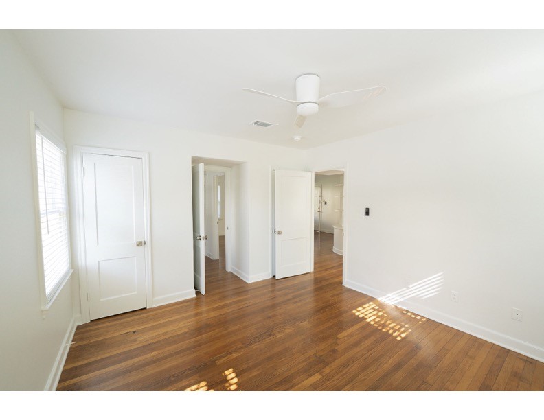 1913 Prospect Street, Unit 5 Houston, TX 77004 - Photo 4 of 17 a view of an empty room with wooden floor and windows