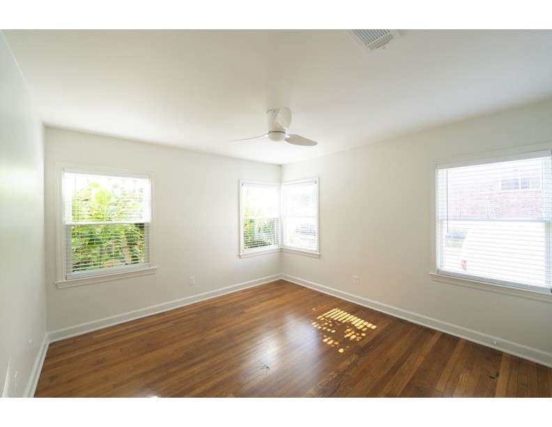 1913 Prospect Street, Unit 5 Houston, TX 77004 - Photo 5 of 17 a view of an empty room with wooden floor and a window