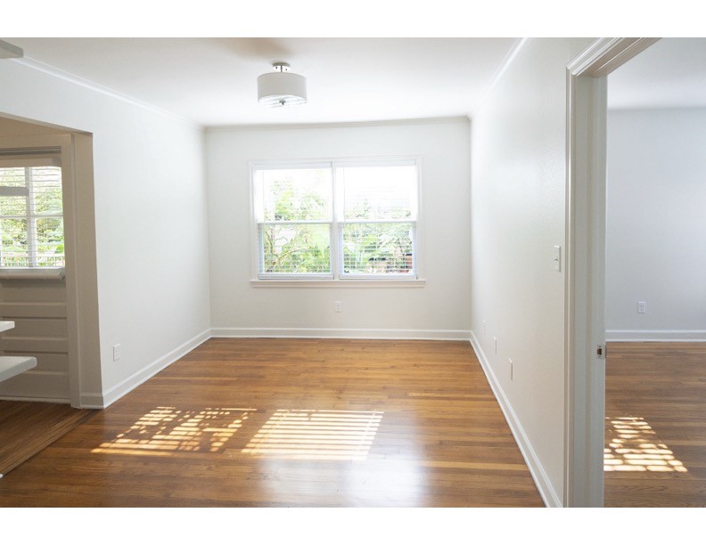 1913 Prospect Street, Unit 5 Houston, TX 77004 - Photo 6 of 17 a view of an empty room with wooden floor and a window