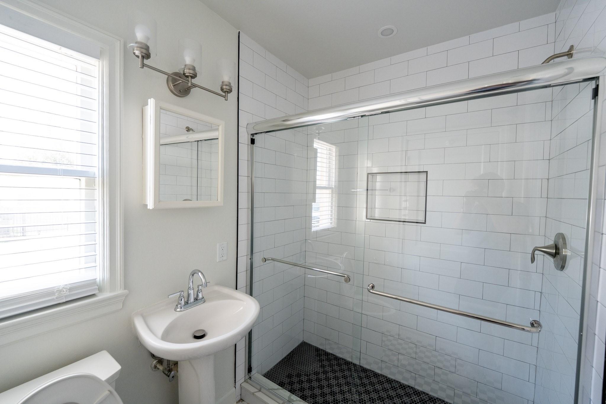 1913 Prospect Street, Unit 5 Houston, TX 77004 - Photo 10 of 17 a bathroom with a sink a window and shower