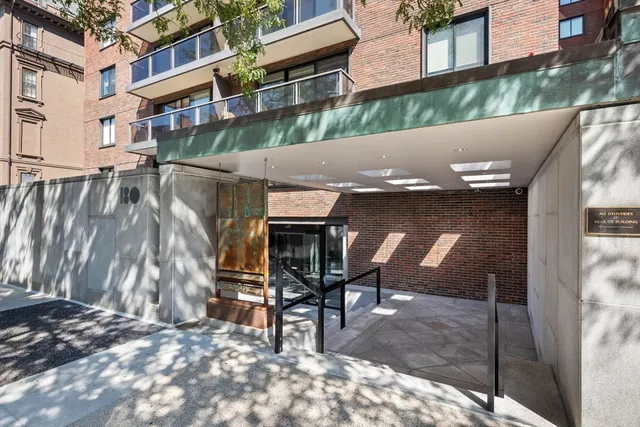 a brick building with a bench in front of it