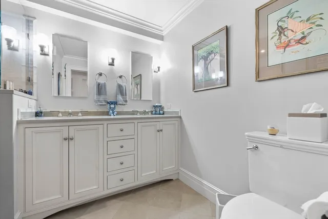 a bathroom with a granite countertop sink mirror and toilet