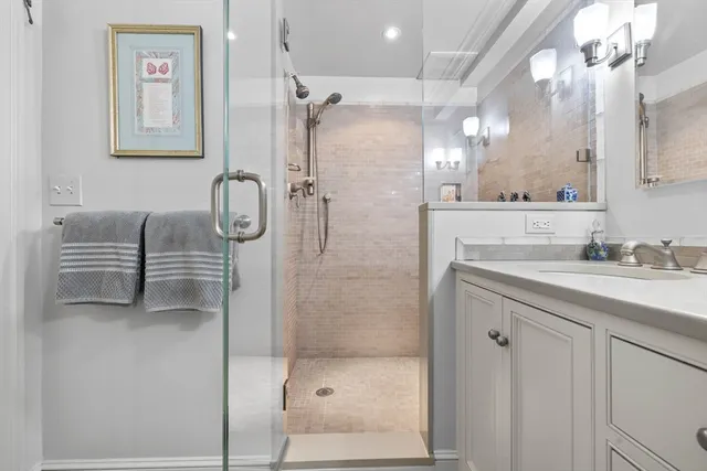 a bathroom with a shower sink and mirror