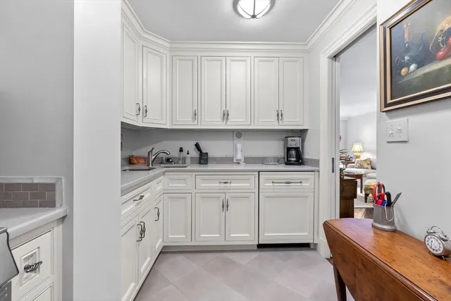 a kitchen with granite countertop white cabinets and white appliances