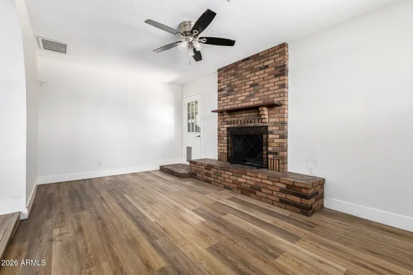 a view of fireplace and wooden floor