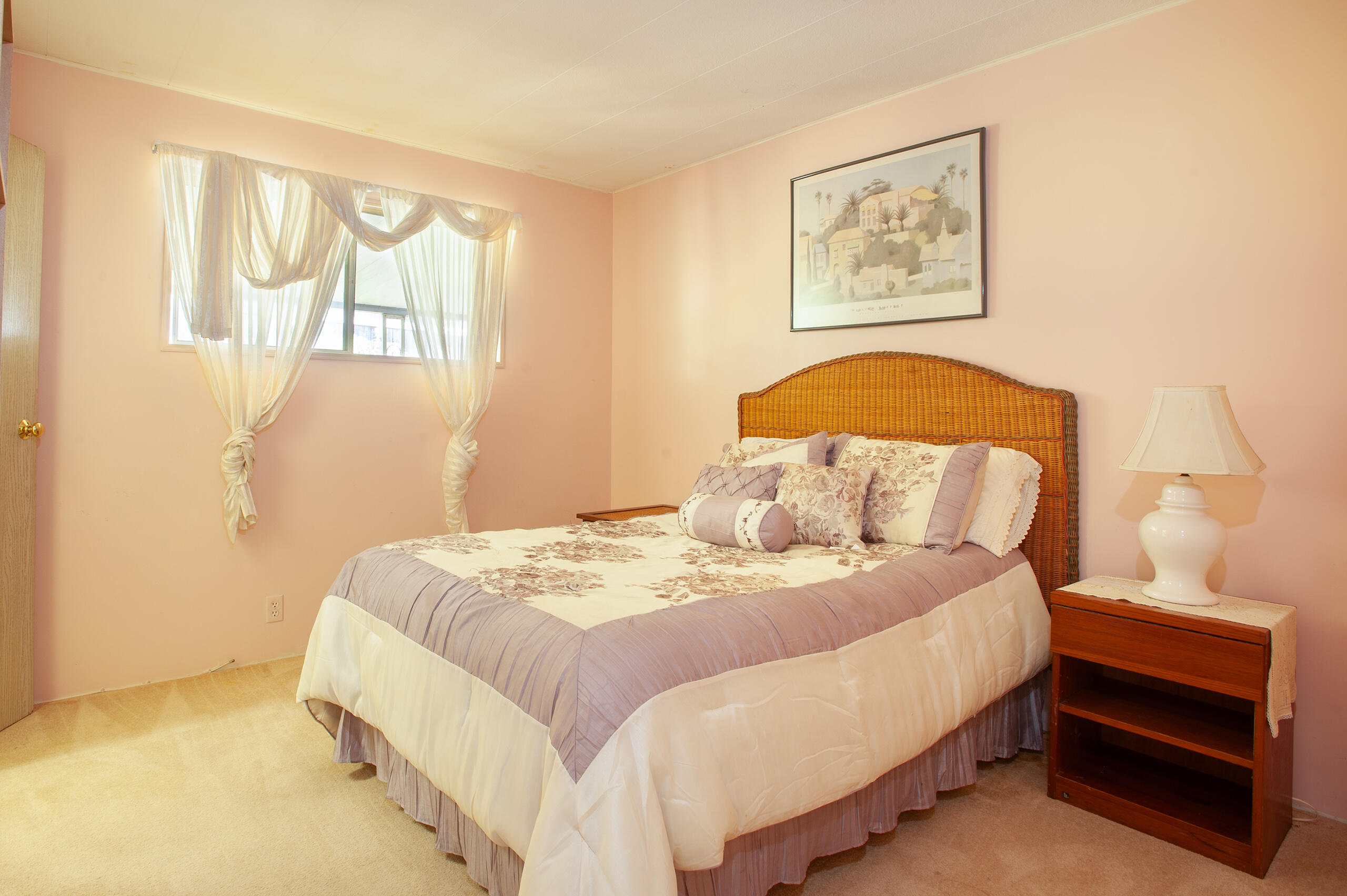 6180 Via Real, Unit 29 Carpinteria, CA 93013 - Photo 13 of 19 a bedroom with a bed and a painting on the wall