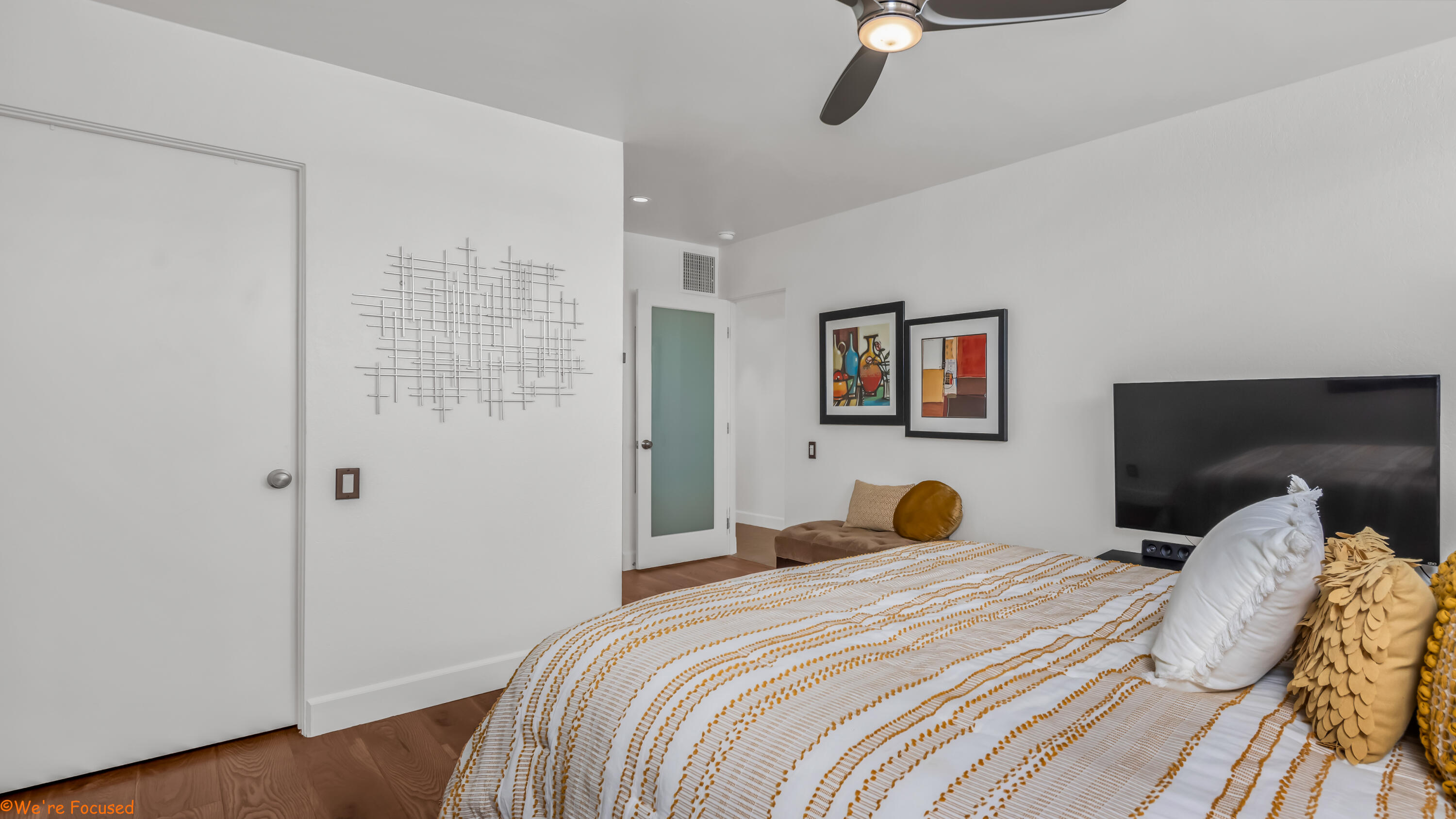 1655 East Palm Canyon Drive, Unit 202 Palm Springs, CA 92264 - Photo 16 of 26 a bedroom with a bed and wooden floor