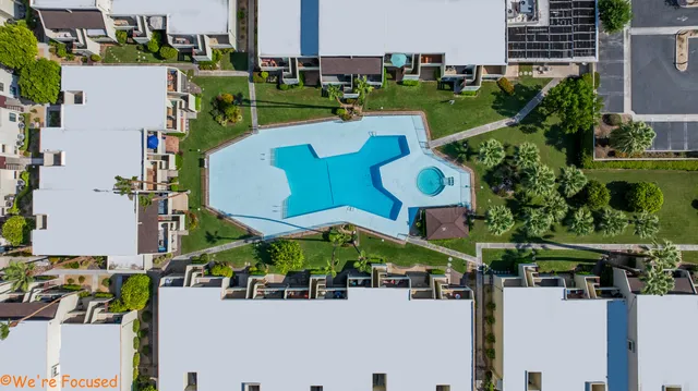 an aerial view of a house with a yard and outdoor seating
