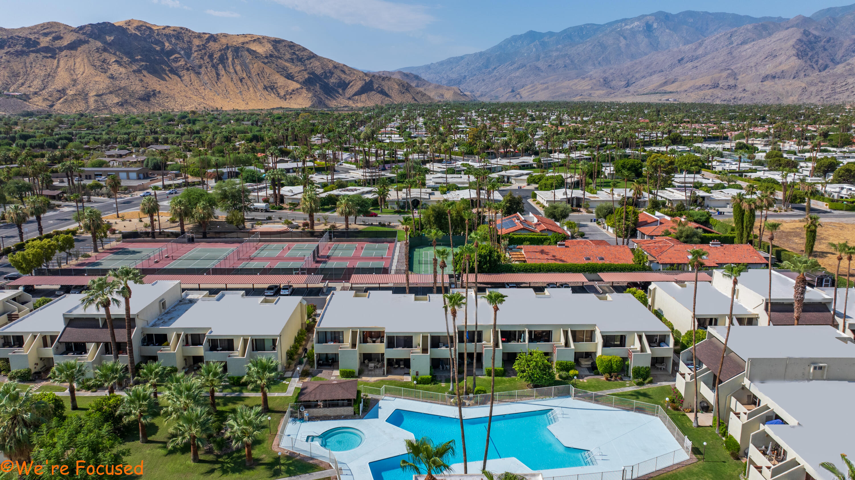 1655 East Palm Canyon Drive, Unit 202 Palm Springs, CA 92264 - Photo 21 of 26 an aerial view of residential houses and outdoor space