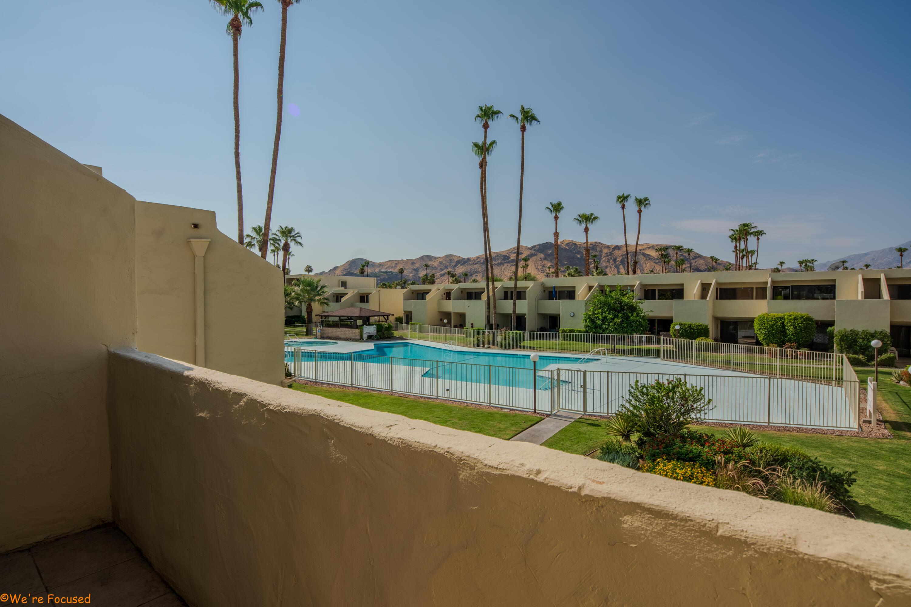 1655 East Palm Canyon Drive, Unit 202 Palm Springs, CA 92264 - Photo 3 of 26 a view of a house with a swimming pool