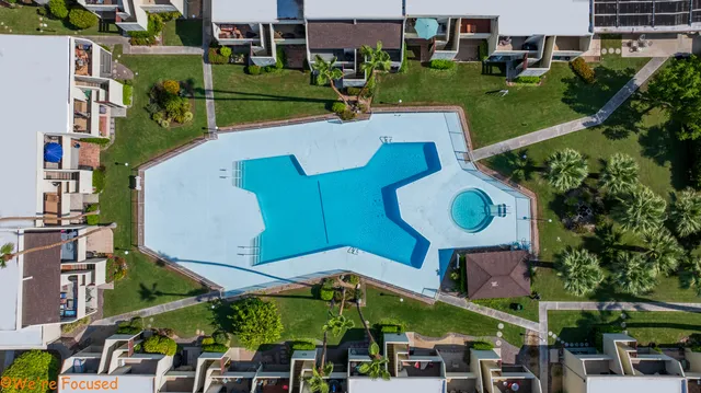 an aerial view of a house with a garden and large trees