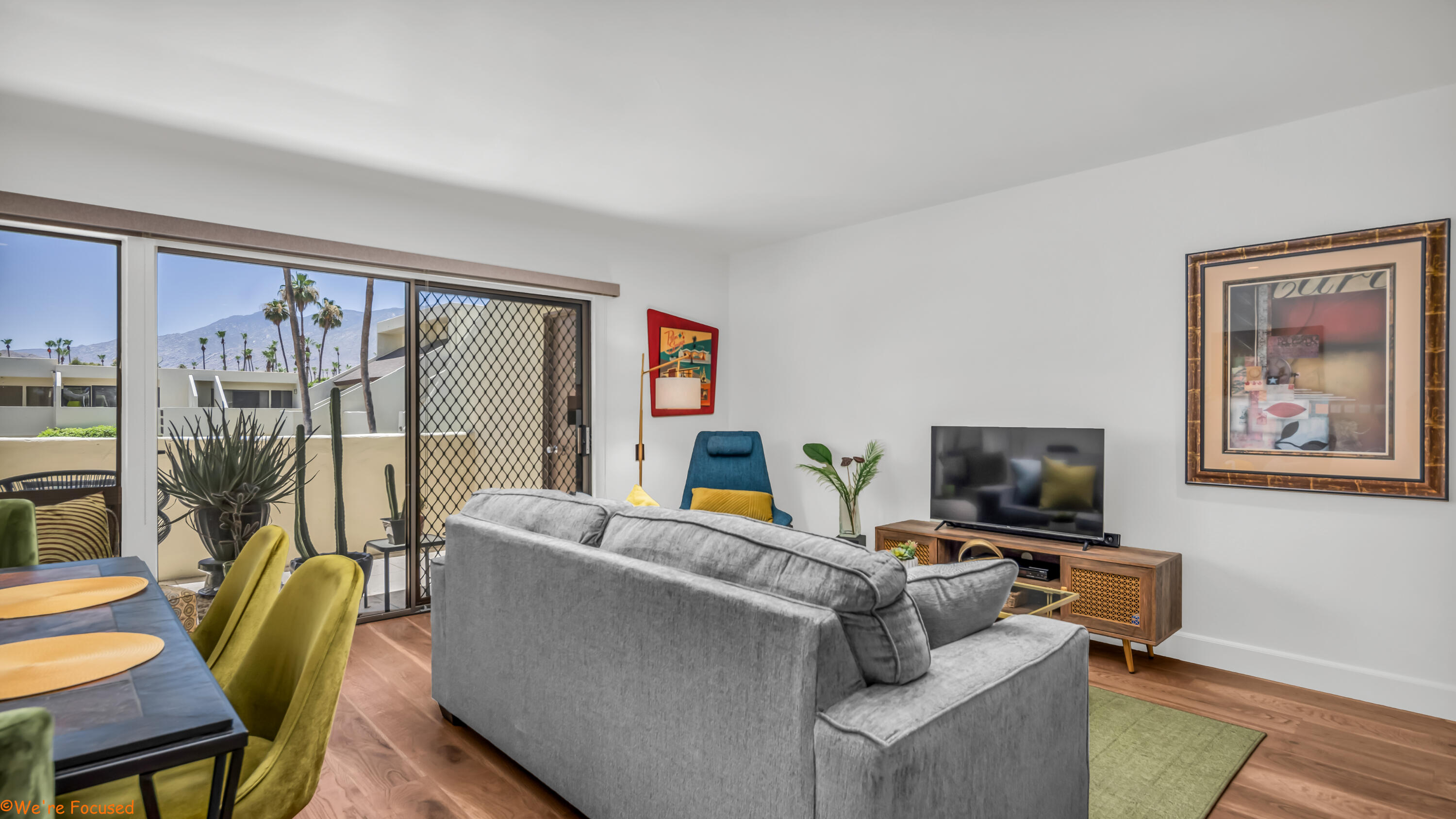 1655 East Palm Canyon Drive, Unit 202 Palm Springs, CA 92264 - Photo 5 of 26 a living room with furniture and a flat screen tv