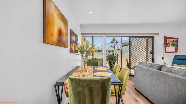 a living room with furniture and a floor to ceiling window