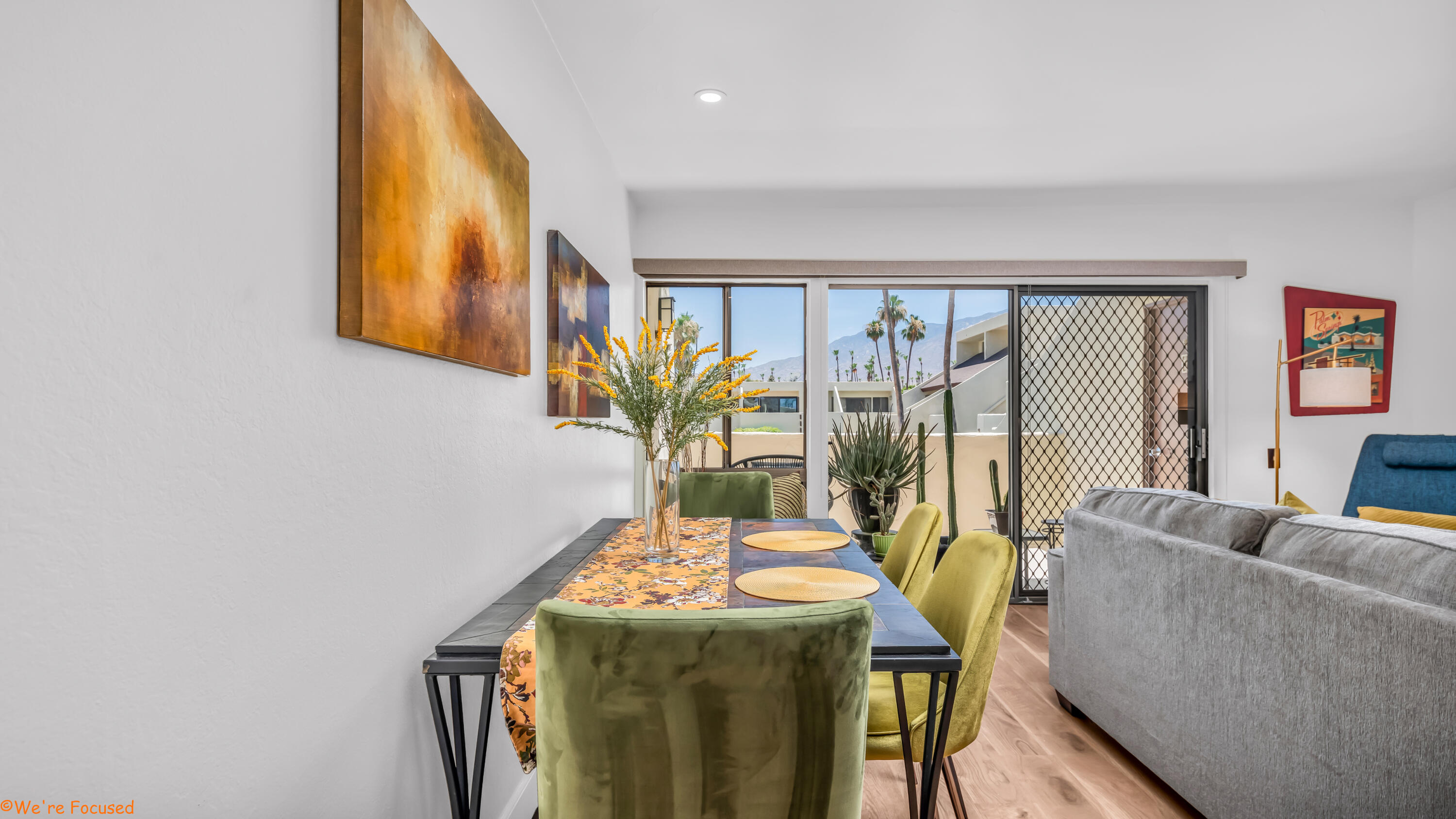 1655 East Palm Canyon Drive, Unit 202 Palm Springs, CA 92264 - Photo 8 of 26 a living room with furniture and a floor to ceiling window
