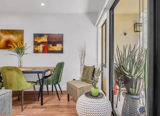 a living room with furniture and a potted plant