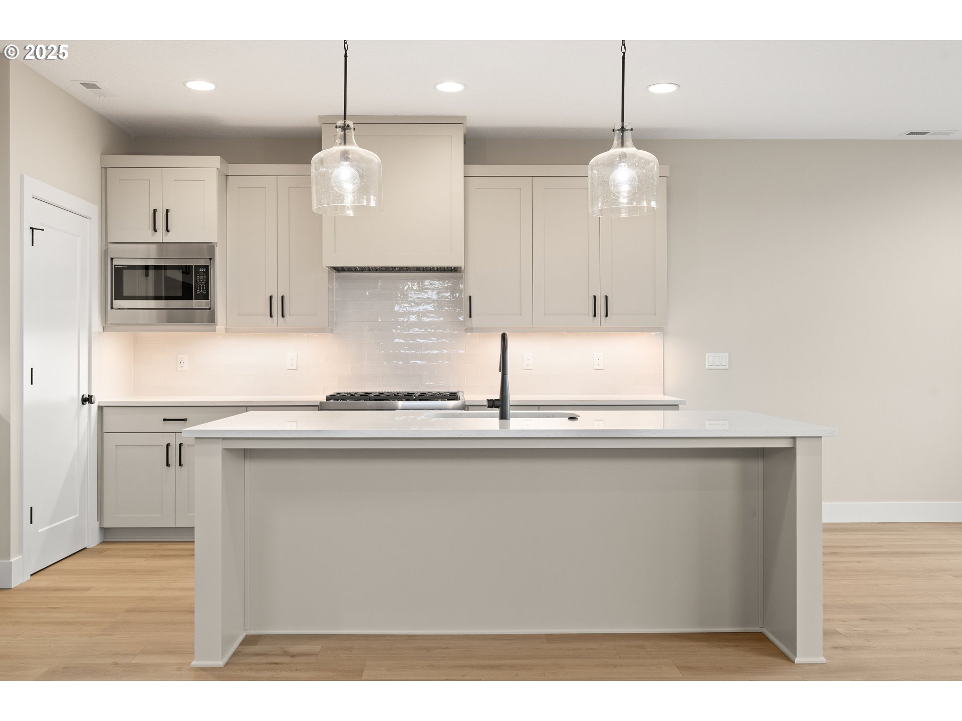 11486 Northwest Elise Lane Portland, OR 97229 - Photo 13 of 48 a kitchen with stainless steel appliances granite countertop a sink a microwave oven a refrigerator and white cabinets