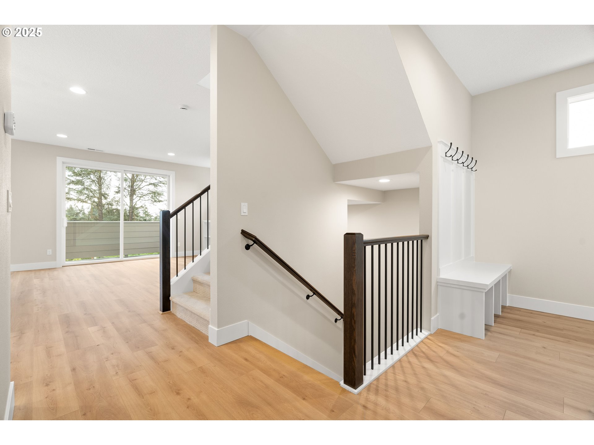 11486 Northwest Elise Lane Portland, OR 97229 - Photo 6 of 48 a view of a hallway with wooden floor and stairs