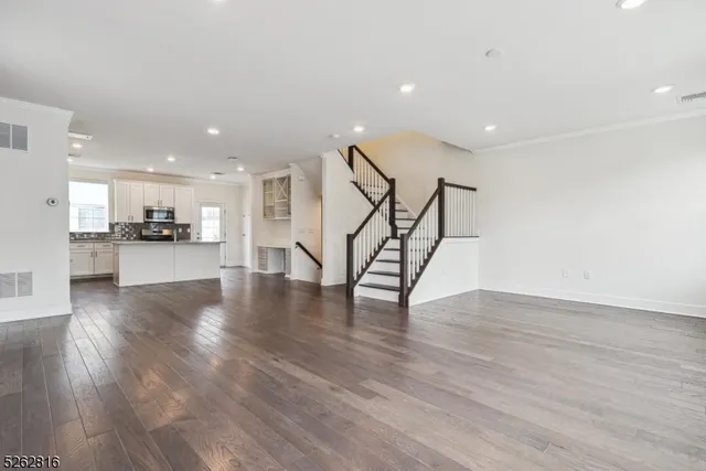 a view of a kitchen with furniture and wooden floor
