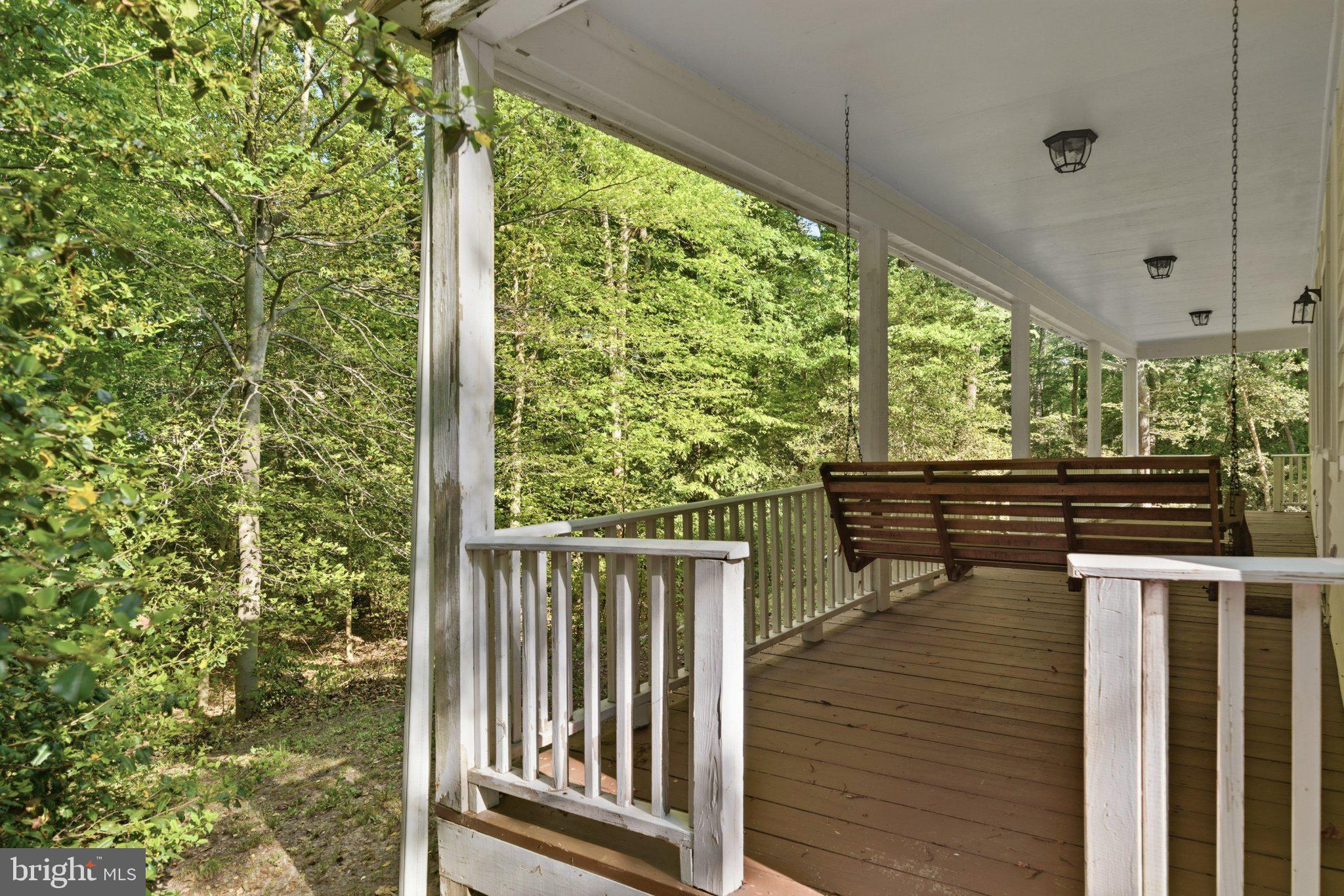 10560 South Faulkner Road Faulkner, MD 20632 - Photo 12 of 60 Serene porch overlooking lush greenery.