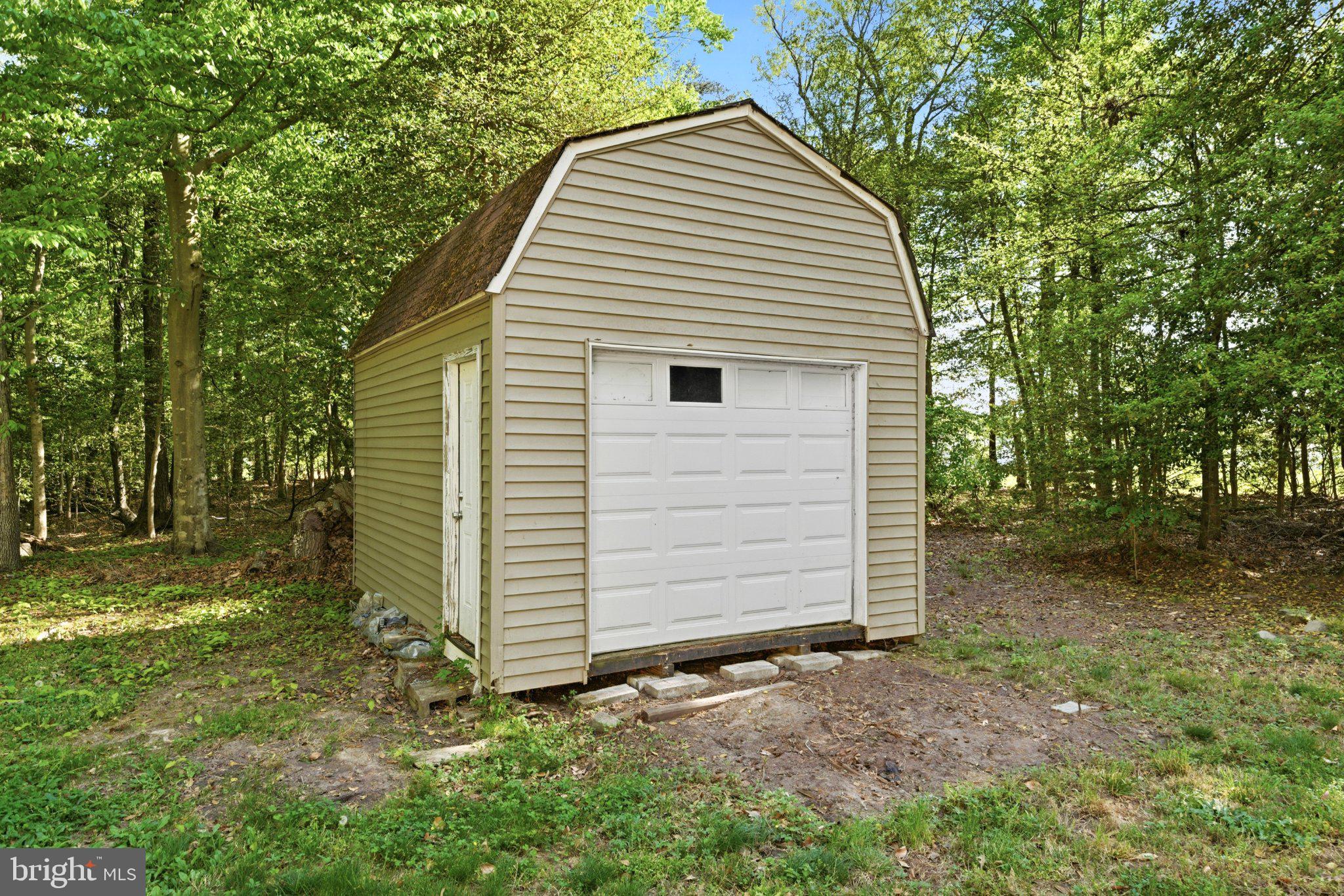10560 South Faulkner Road Faulkner, MD 20632 - Photo 14 of 60 Charming shed nestled in serene woods.