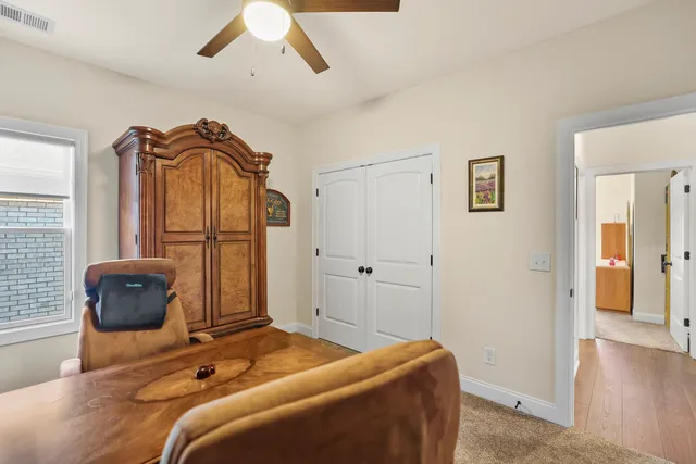 a living room with fireplace furniture and a rug