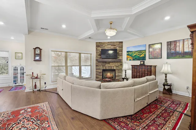 a large kitchen with stainless steel appliances granite countertop a lot of counter space and wooden floor