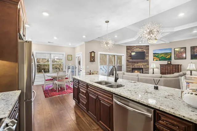 a view of a hallway with wooden floor and a livingroom view