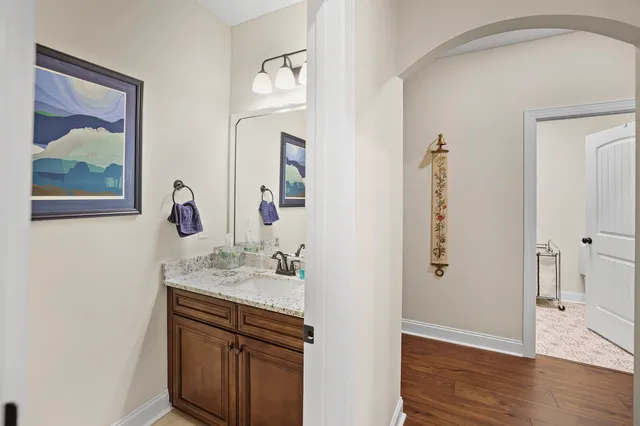 a view of a hallway with wooden floor and entryway